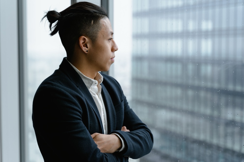 A man pausing to think clearly, looking out at the city
